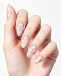 Ethereal Pearl | Iridescent Acetate Shell & Liquid Metal — press-on nails worn on hand, close view