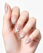 Celestial Stars & Nude Cat-Eye — press-on nails worn on hand, close view