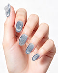 Steel Blue Cat-Eye Dewdrop — press-on nails worn on hand, close view