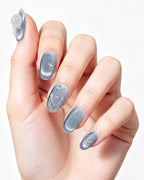 Steel Blue Cat-Eye Dewdrop — press-on nails worn on hand, close view