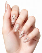 Champagne Dew — press-on nails worn on hand, close view