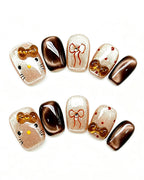 Caramel Brown Cat Eye — gold press-on nail set, full set, styled arrangement