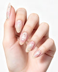 Soft Peach Blush Crystal — press-on nails worn on hand, close view
