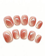 Amber Rosewood Jelly — pink press-on nail set, full set, styled arrangement