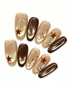 Mocha Starlet — gold press-on nail set, full set, styled arrangement