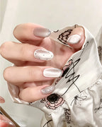 Mist Shrouds Camellia — press-on nails worn on hand, close view