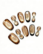 Golden Mocha Cat-Eye — gold press-on nail set, full set, styled arrangement