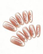 Nude Pink Shimmer Crystal Nails — gold press-on nail set, full set, styled arrangement