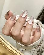 Mist Shrouds Camellia — press-on nails worn on hand, alternate angle
