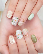 Jasmine Peach — press-on nails worn on hand