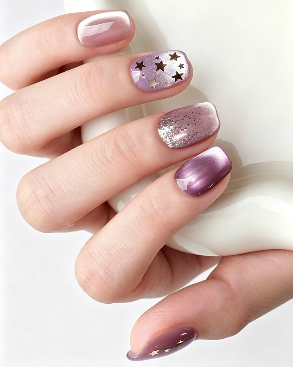 Dusty Rose Cat Eye — press-on nails worn on hand
