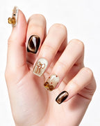 Caramel Brown Cat Eye — press-on nails worn on hand, close view