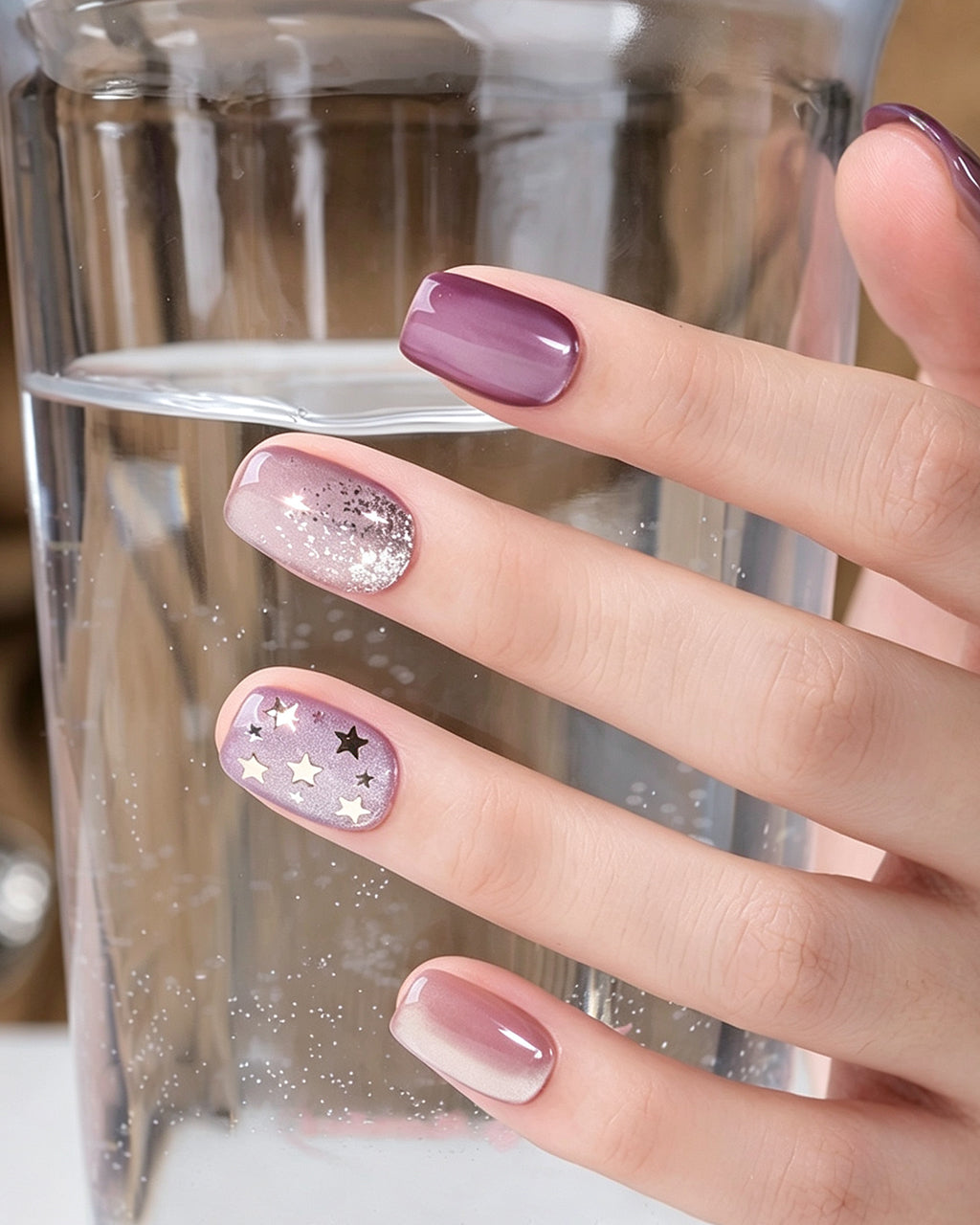 Dusty Rose Cat Eye — press-on nails worn on hand, close view