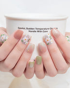 Jasmine Peach — press-on nails worn on hand, close view
