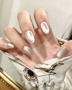 Mist Shrouds Camellia — press-on nails worn on hand