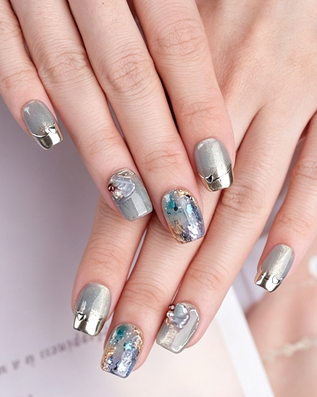 Dew Bubbles | Ice Blue Cat Eye & Chrome French Tip — press-on nails worn on hand, close view