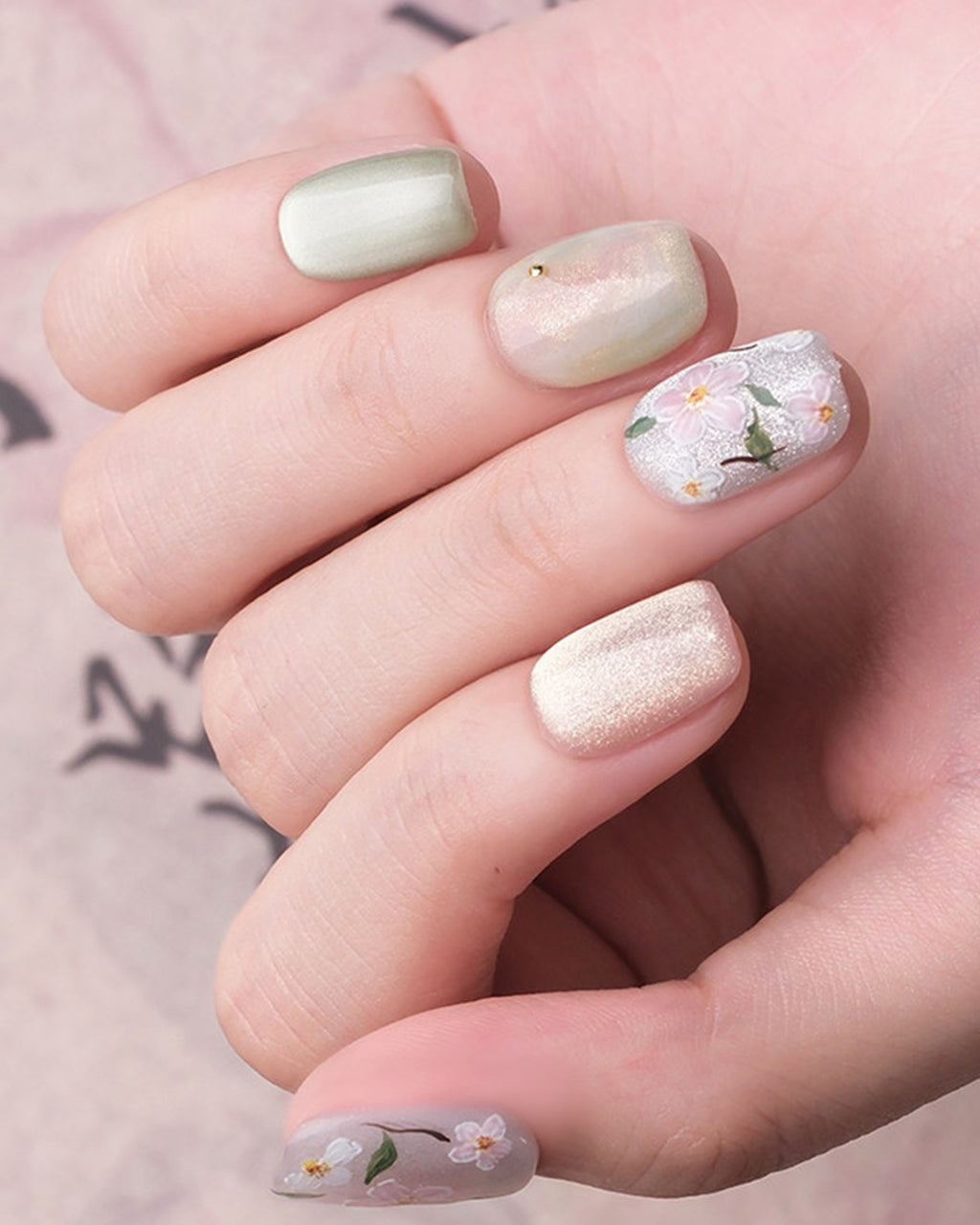 Jasmine Peach — press-on nails worn on hand, close view